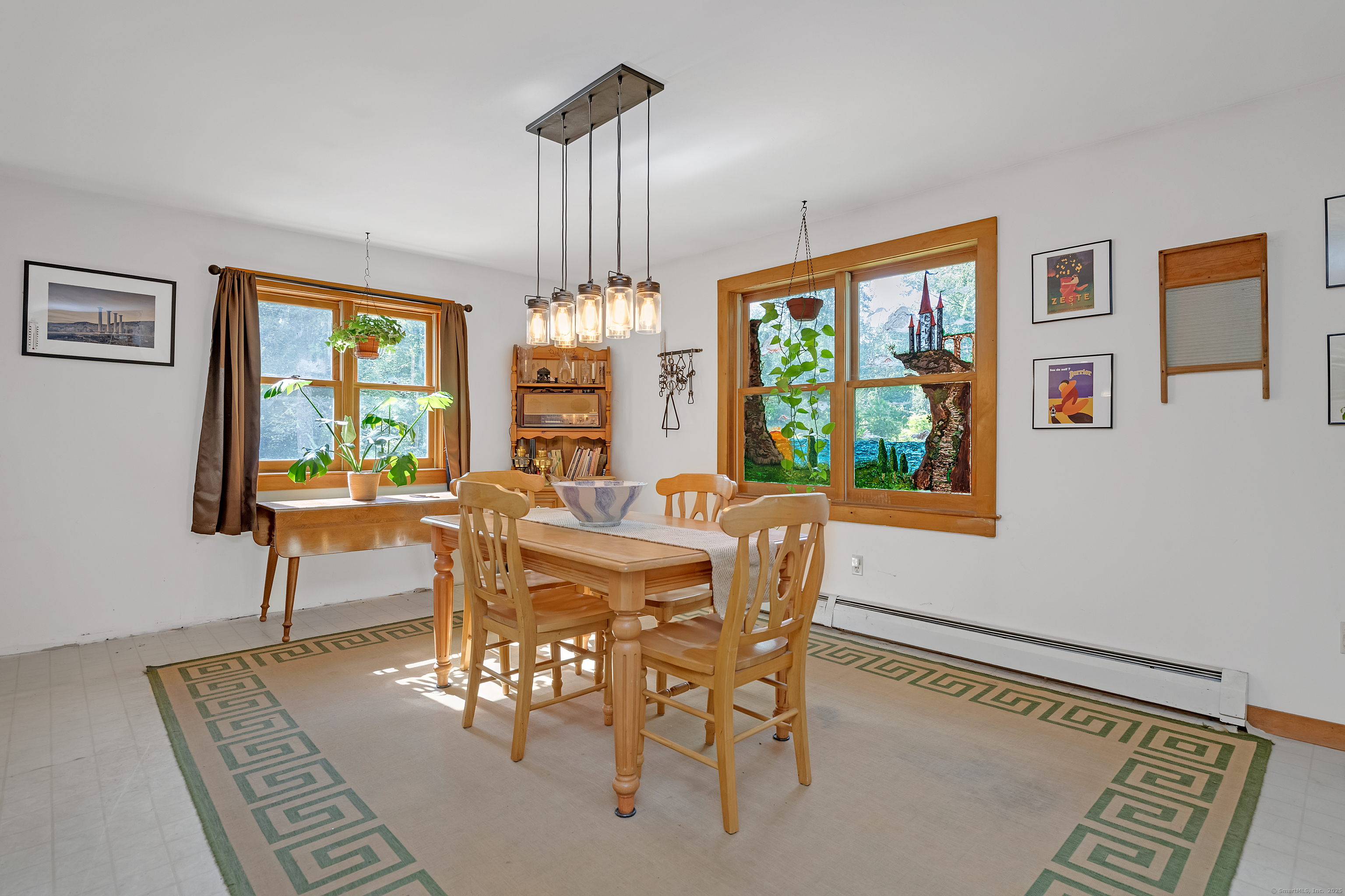 55 Mallory Road Roxbury, CT 06783 - Photo 20 of 34 a view of a dining room with furniture a rug and wooden floor