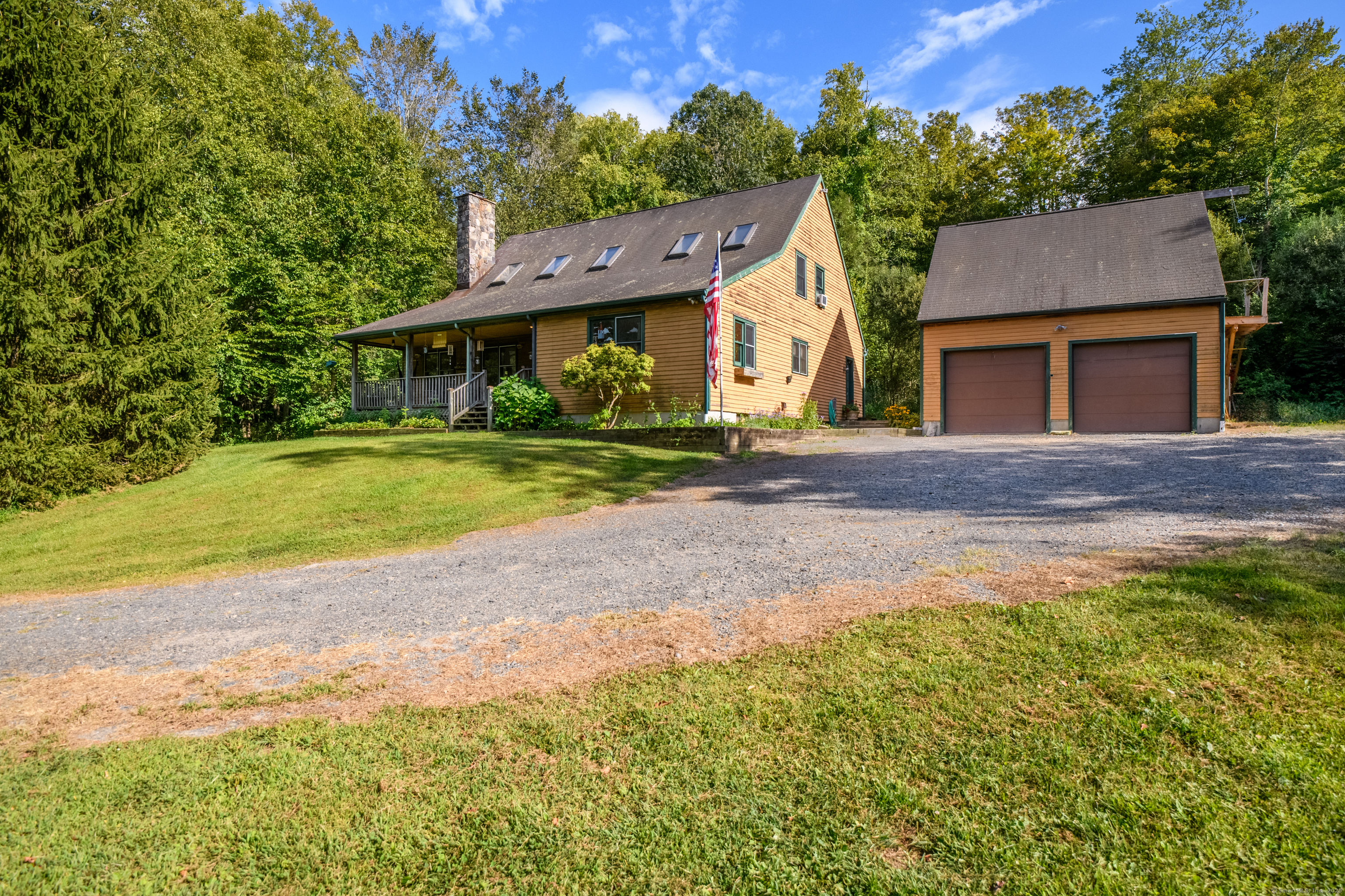 55 Mallory Road Roxbury, CT 06783 - Photo 2 of 34 a front view of a house with a yard and garage