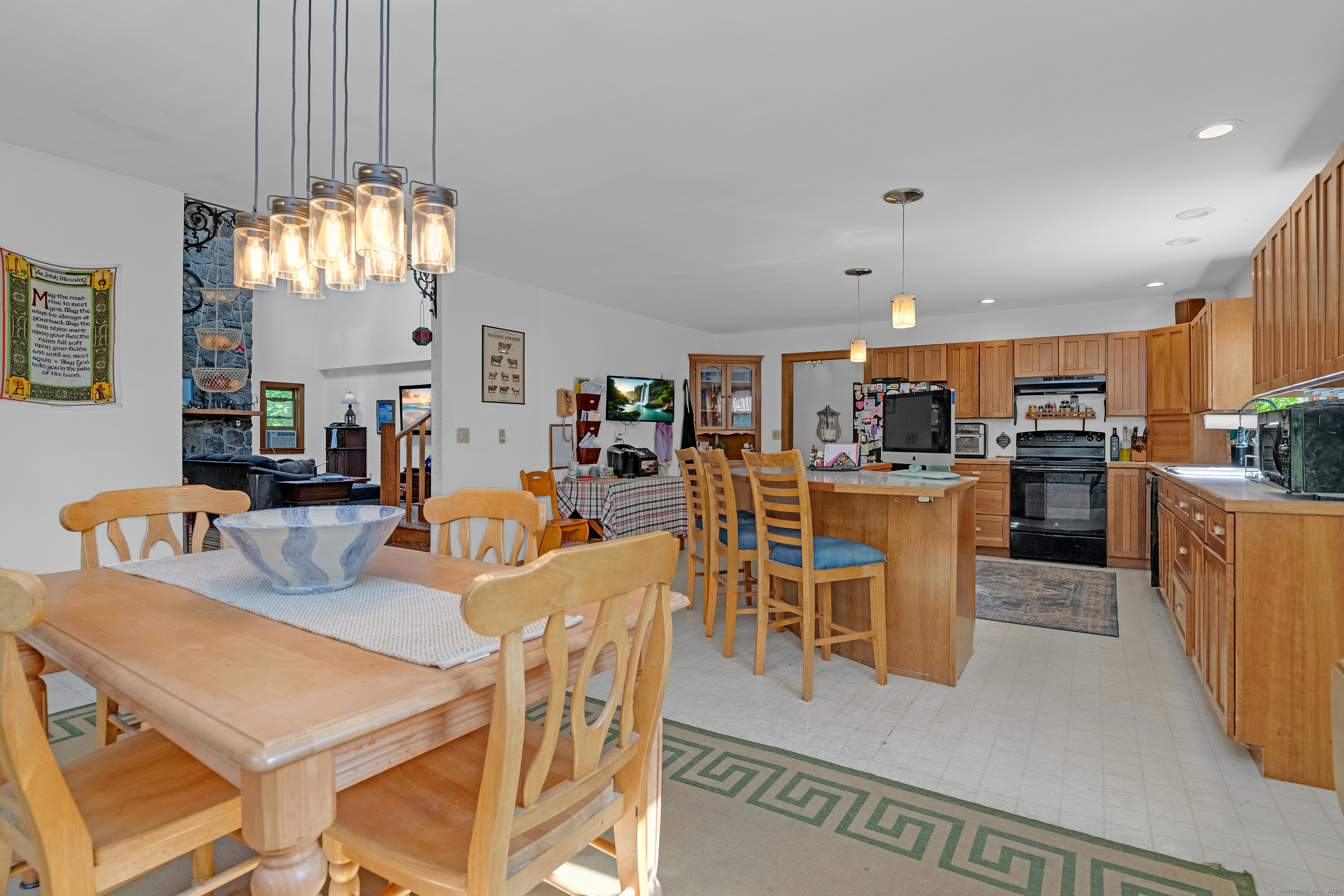 55 Mallory Road Roxbury, CT 06783 - Photo 21 of 34 a view of a dining room with furniture a chandelier and kitchen view