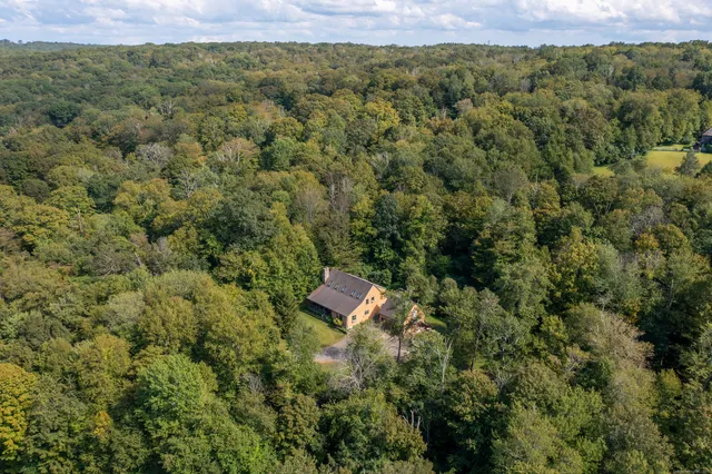 an aerial view of a house with a yard