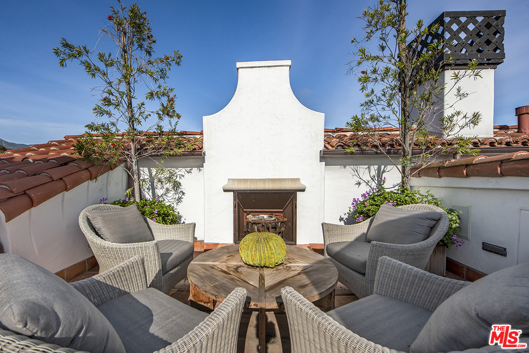 1286 Coast Village Road Montecito, CA 93108 - Photo 1 of 23 a living room with furniture a chandelier and a fireplace