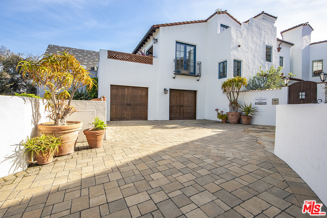 1286 Coast Village Road Montecito, CA 93108 - Photo 2 of 23 a view of a patio with a table and chairs and potted plants