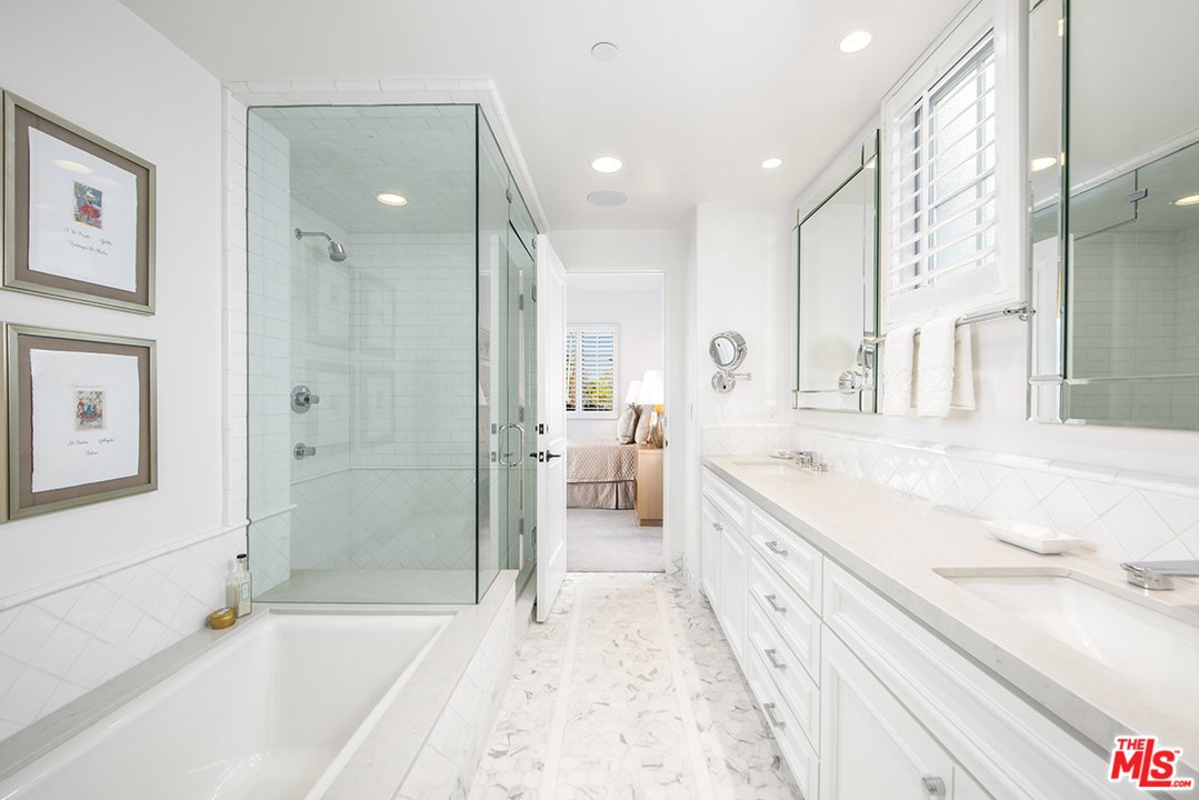 1286 Coast Village Road Montecito, CA 93108 - Photo 16 of 23 a spacious bathroom with a granite countertop tub sink a shower and a mirror