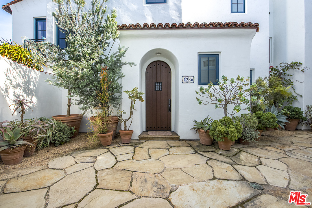 1286 Coast Village Road Montecito, CA 93108 - Photo 3 of 23 a front view of a house with garden