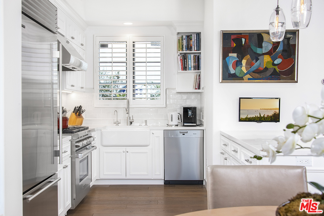 1286 Coast Village Road Montecito, CA 93108 - Photo 6 of 23 a kitchen with stainless steel appliances a stove a sink and a refrigerator