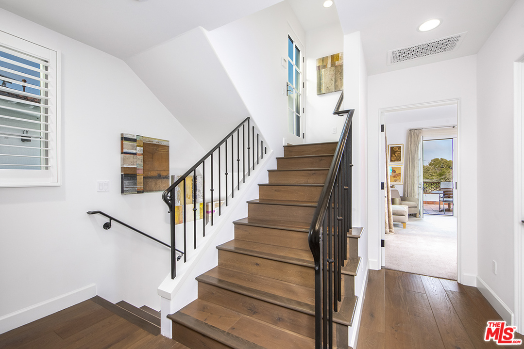 1286 Coast Village Road Montecito, CA 93108 - Photo 10 of 23 a view of staircase with wooden floor and a rug