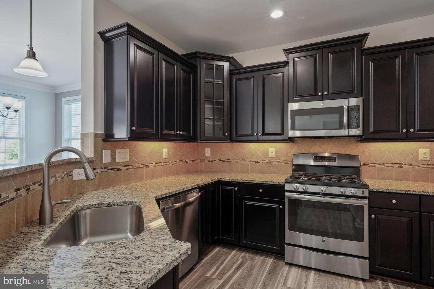 42550 Sunset Ridge Square Ashburn, VA 20148 - Photo 11 of 36 a kitchen with granite countertop a sink stainless steel appliances and cabinets