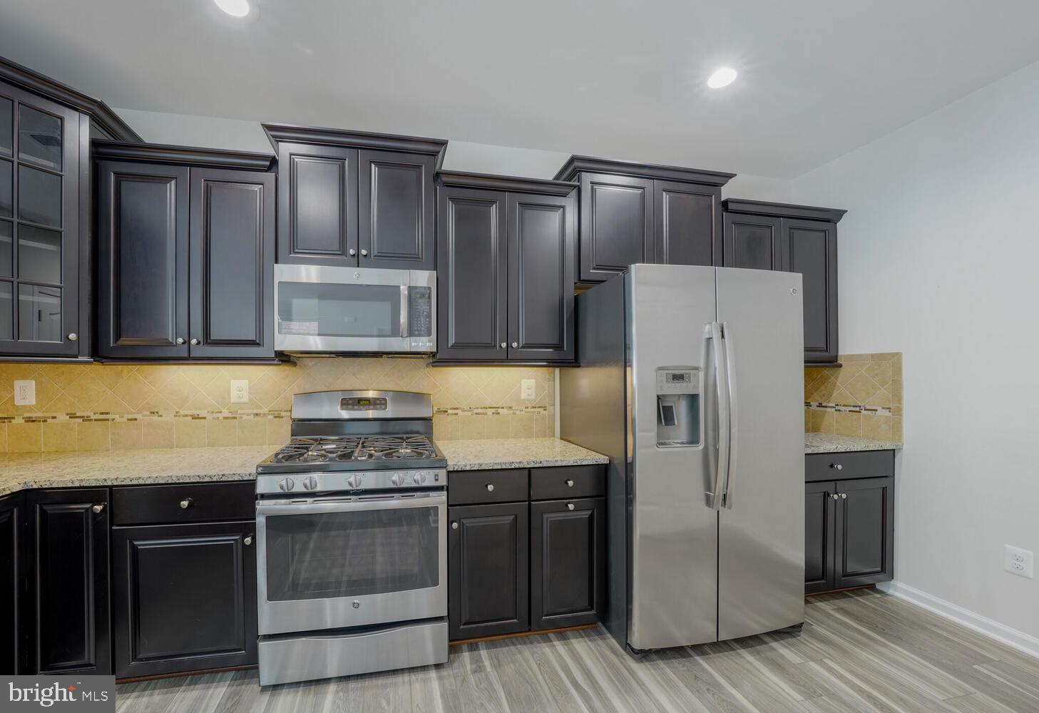 42550 Sunset Ridge Square Ashburn, VA 20148 - Photo 13 of 36 a kitchen with stainless steel appliances granite countertop a refrigerator stove and sink