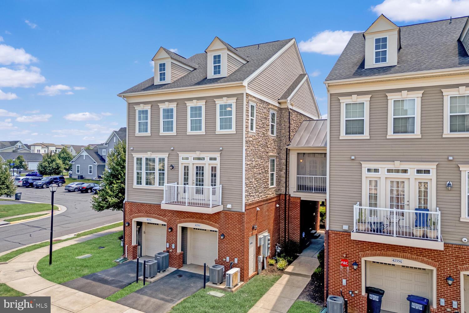 42550 Sunset Ridge Square Ashburn, VA 20148 - Photo 2 of 36 a front view of a residential apartment building with a yard