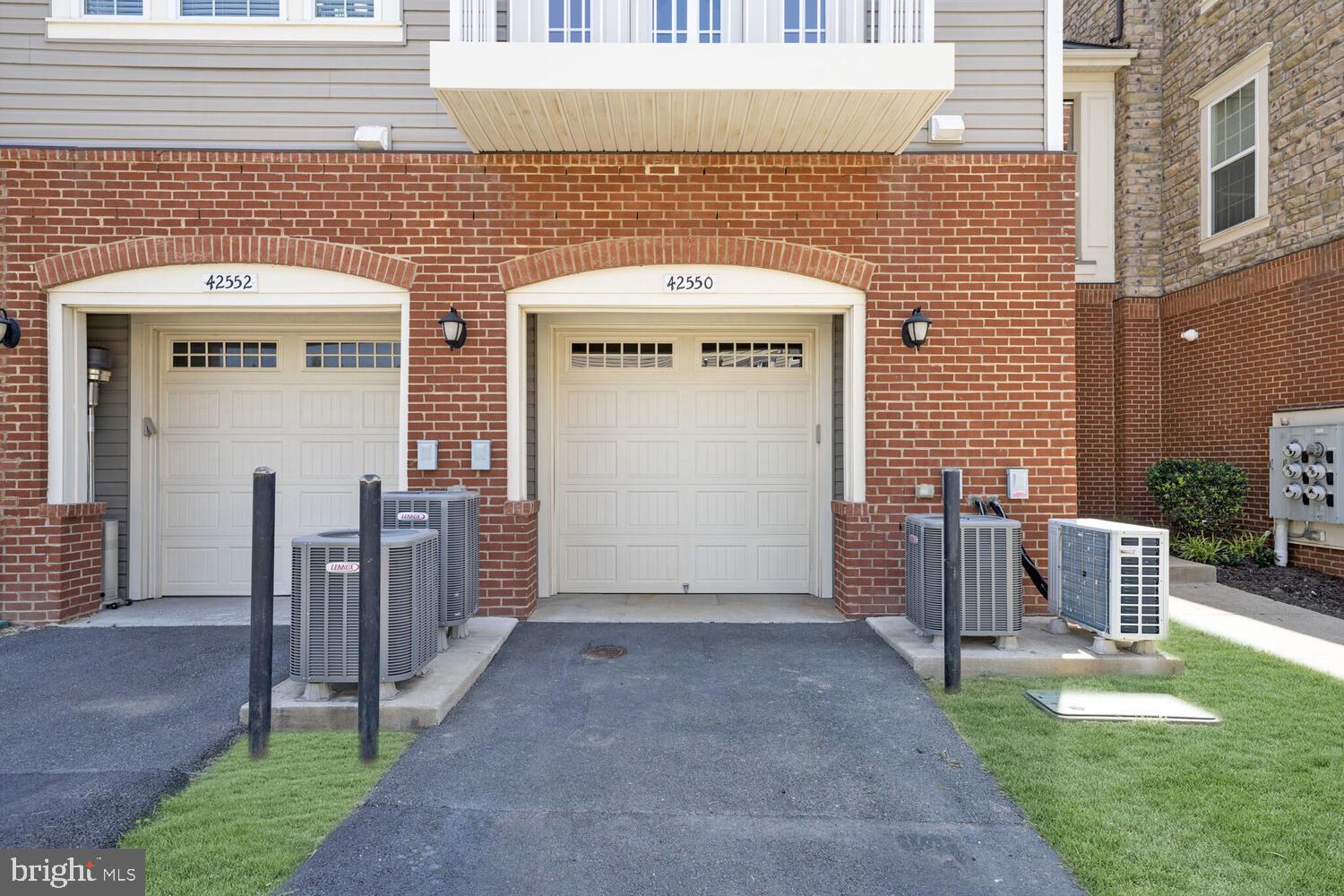 42550 Sunset Ridge Square Ashburn, VA 20148 - Photo 32 of 36 a front view of a building with garden