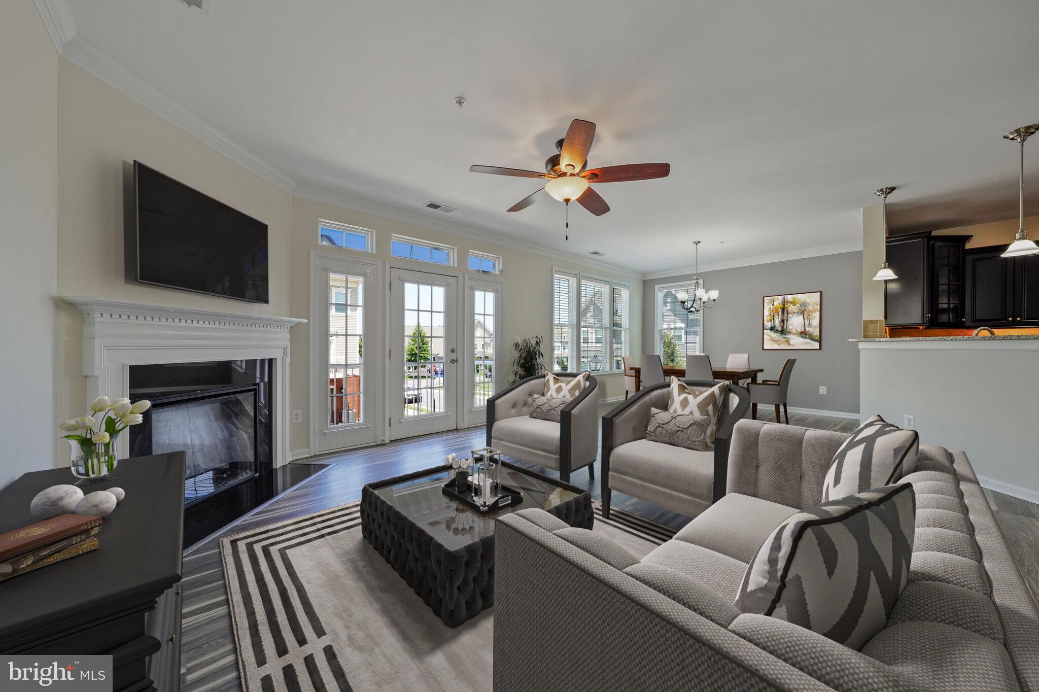 42550 Sunset Ridge Square Ashburn, VA 20148 - Photo 5 of 36 a living room with furniture fireplace and a flat screen tv