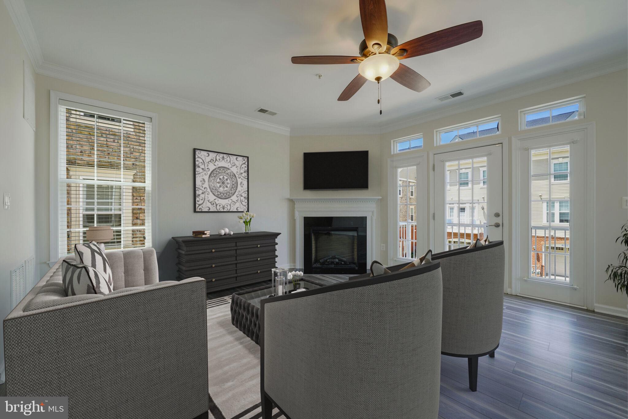 42550 Sunset Ridge Square Ashburn, VA 20148 - Photo 6 of 36 a living room with furniture a fireplace and a flat screen tv