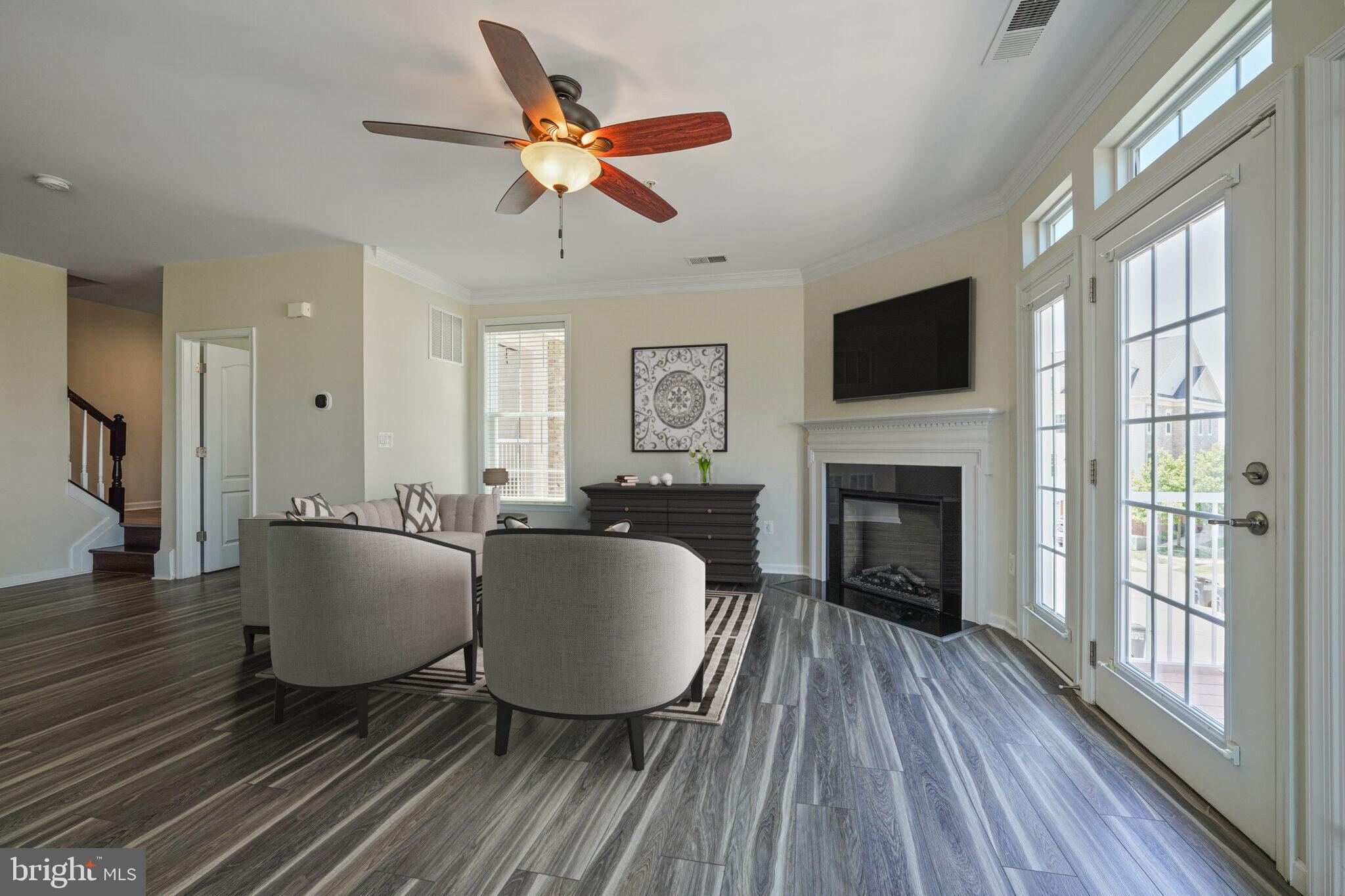 42550 Sunset Ridge Square Ashburn, VA 20148 - Photo 7 of 36 a living room with furniture a fireplace and a flat screen tv