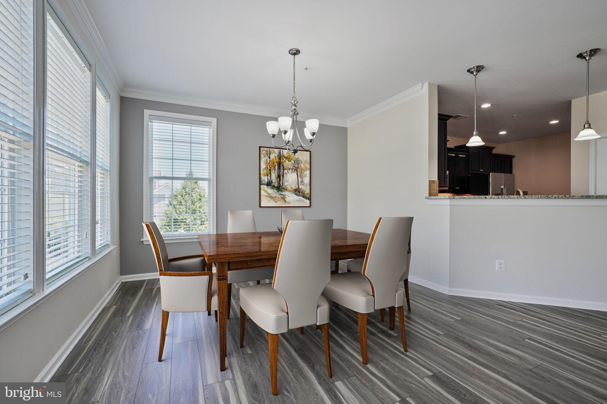 42550 Sunset Ridge Square Ashburn, VA 20148 - Photo 9 of 36 a dining room with furniture a chandelier and wooden floor
