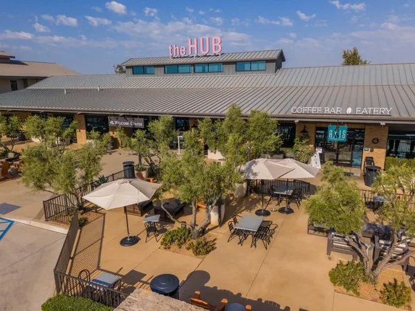 a view of a patio with couches table and chairs and potted plants