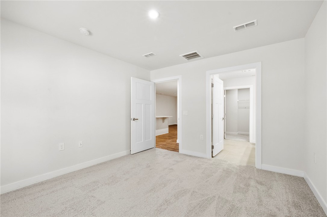 506 Roan Creek Trail Anderson, SC 29621 - Photo 14 of 33 This spacious room offers comfort and versatility, perfect for relaxation or productive activities.
