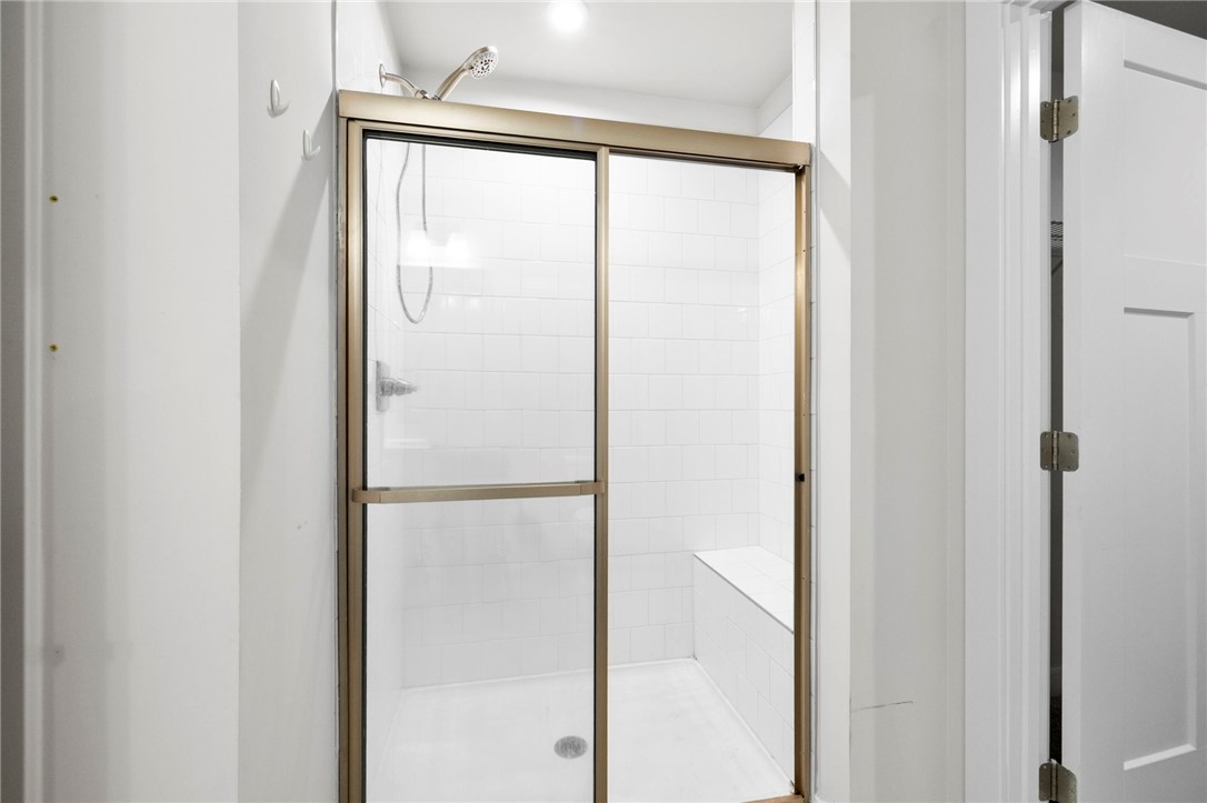 506 Roan Creek Trail Anderson, SC 29621 - Photo 18 of 33 This clean shower features tiled walls and a built-in bench for comfort and convenience.