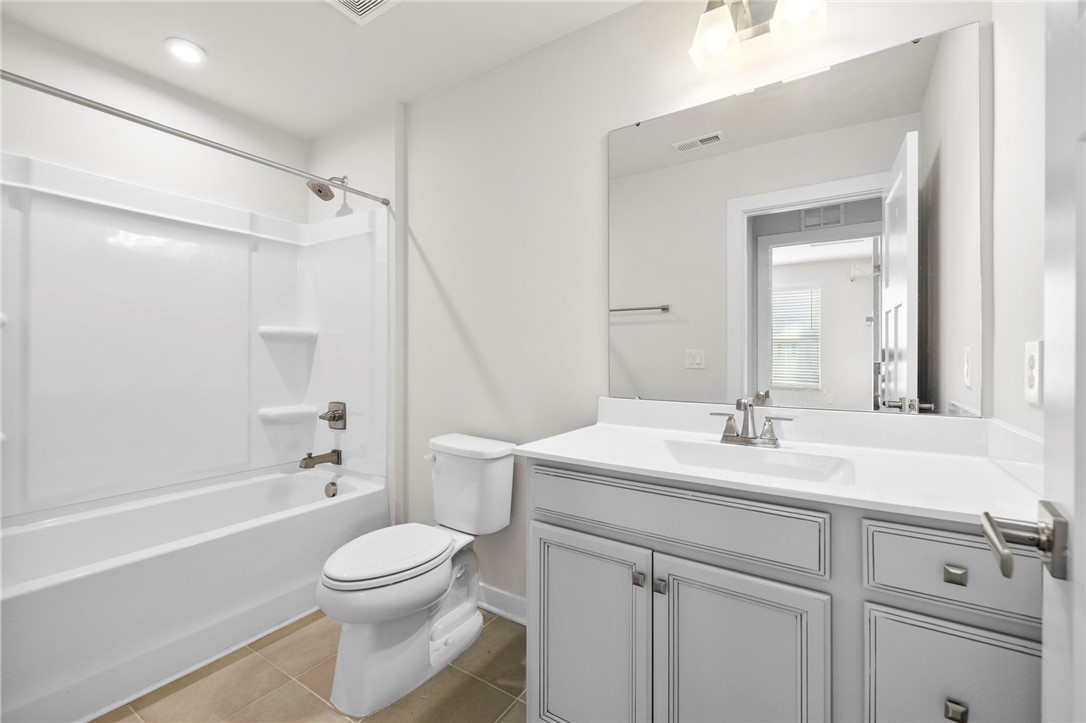 506 Roan Creek Trail Anderson, SC 29621 - Photo 24 of 33 This bathroom features a contemporary vanity and a pristine tub with a shower for everyday comfort.