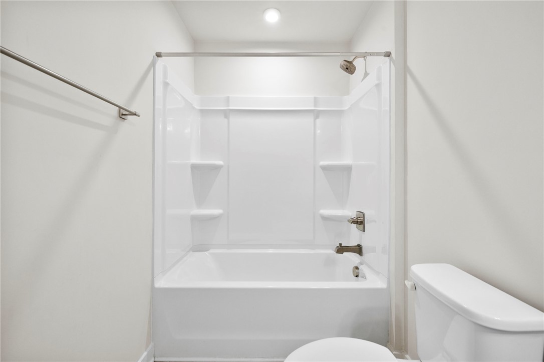 506 Roan Creek Trail Anderson, SC 29621 - Photo 25 of 33 This modern bathroom features a clean tub and shower combination with essential fixtures.