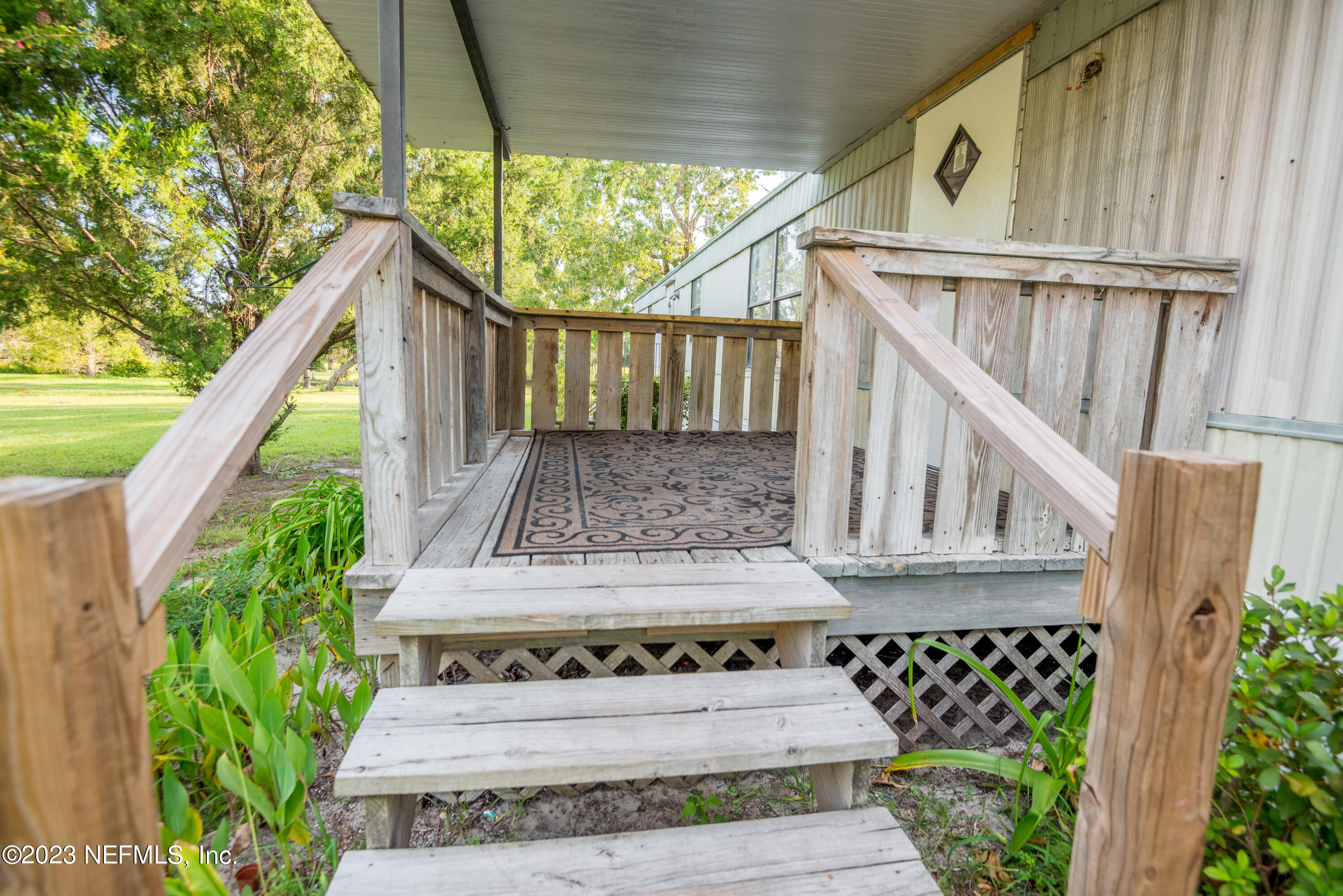 7230 Oakhill Road Keystone Heights, FL 32656 - Photo 3 of 38 a view of wooden house with a small yard and wooden floor