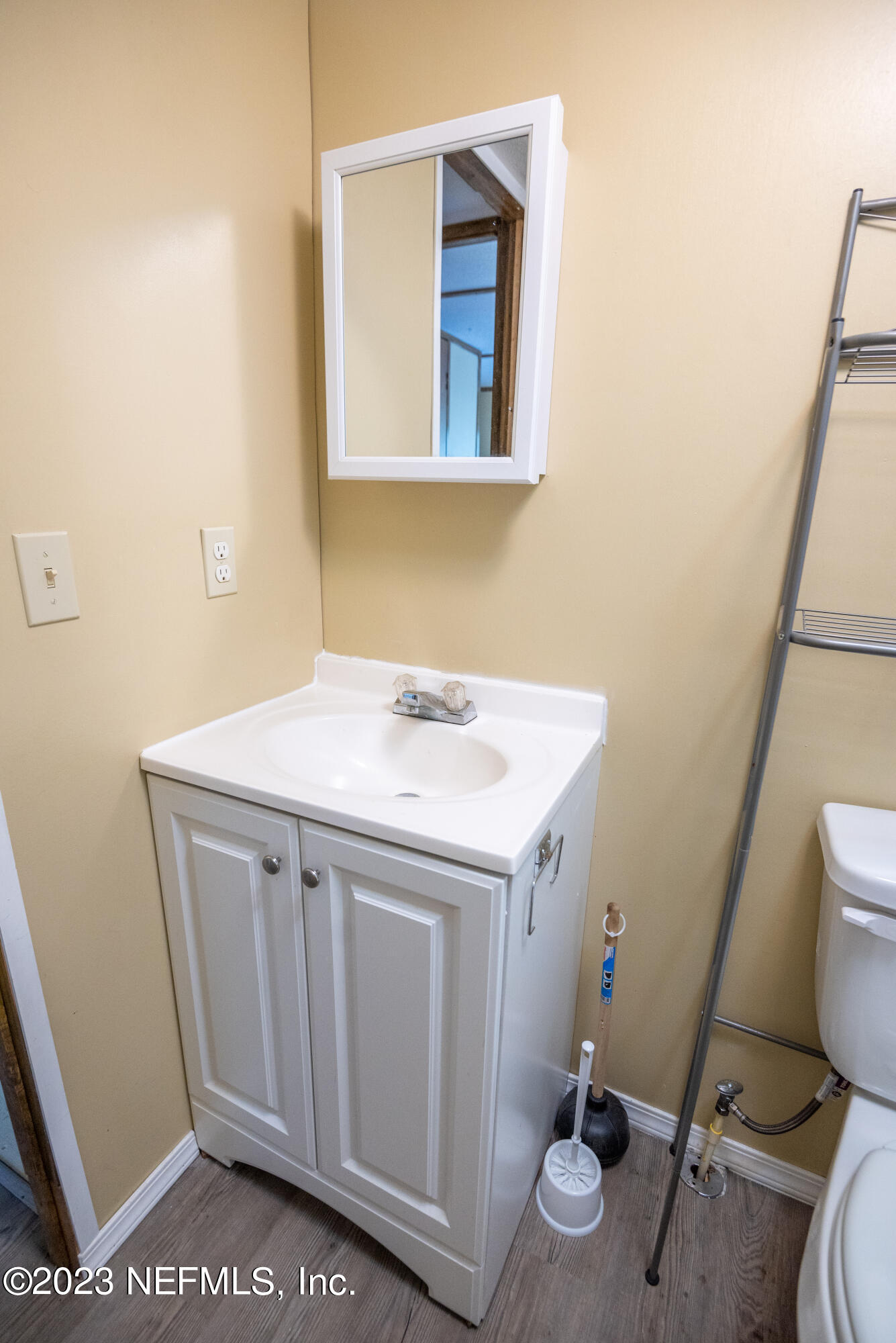 7230 Oakhill Road Keystone Heights, FL 32656 - Photo 34 of 38 a bathroom with a sink a toilet a mirror and vanity