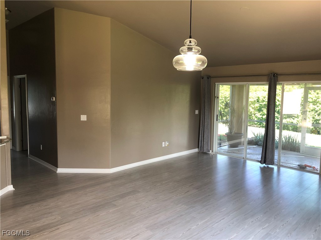 7500 Cameron Circle Fort Myers, FL 33912 - Photo 11 of 12 a view of an empty room with wooden floor and a window