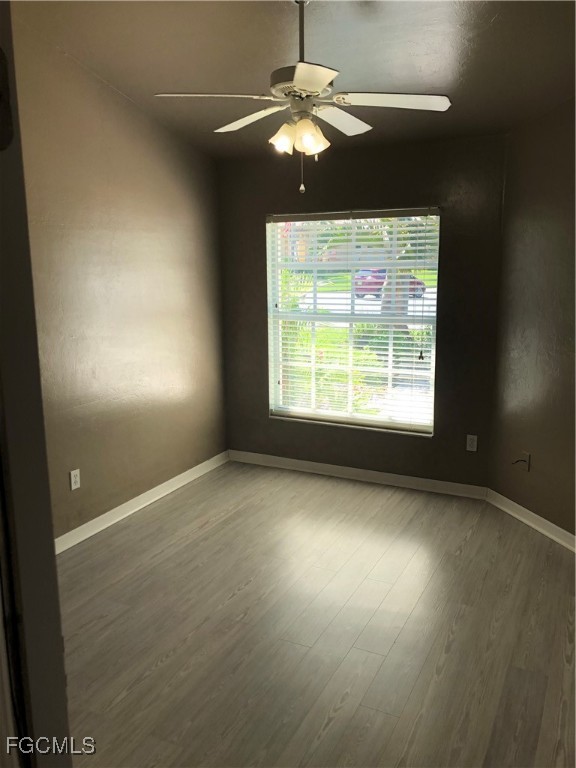 7500 Cameron Circle Fort Myers, FL 33912 - Photo 12 of 12 an empty room with windows and fan