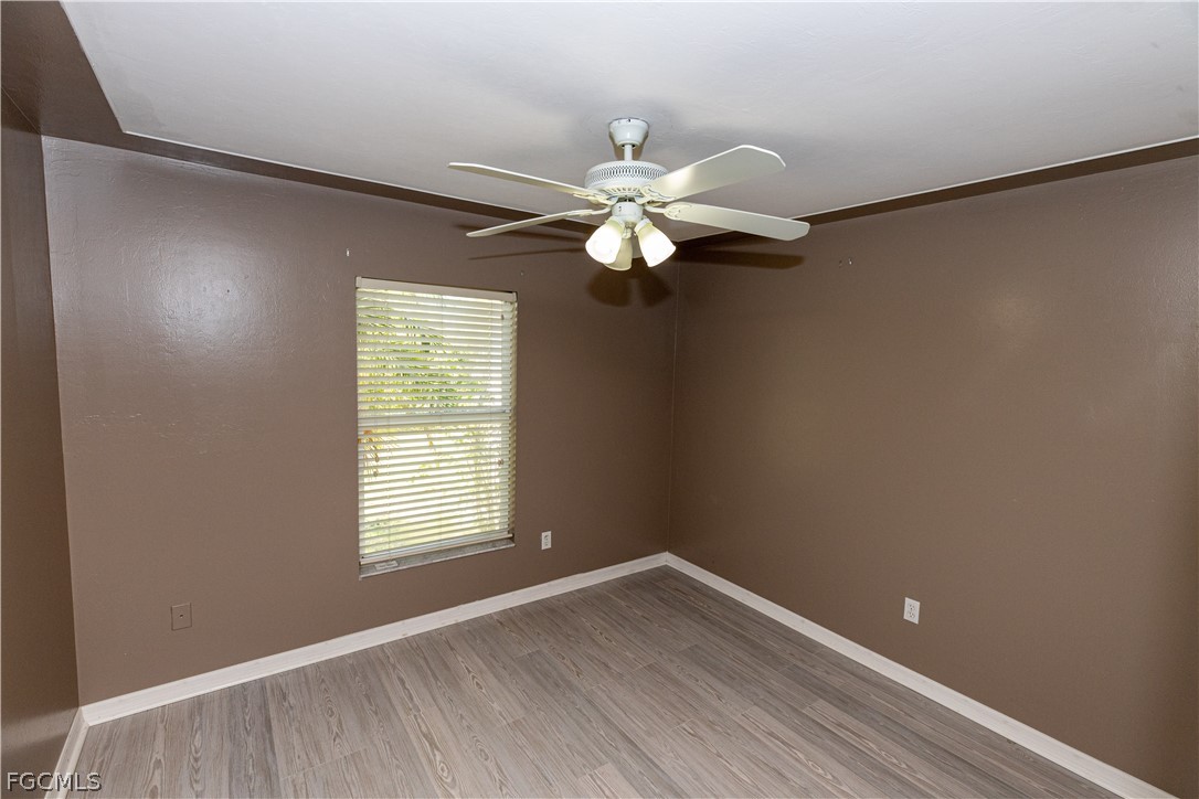 7500 Cameron Circle Fort Myers, FL 33912 - Photo 17 of 21 wooden floor in an empty room with a window