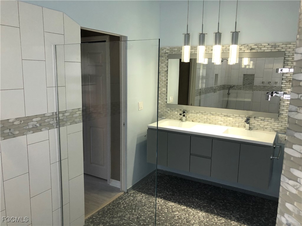 7500 Cameron Circle Fort Myers, FL 33912 - Photo 6 of 12 a bathroom with a shower sink and mirror