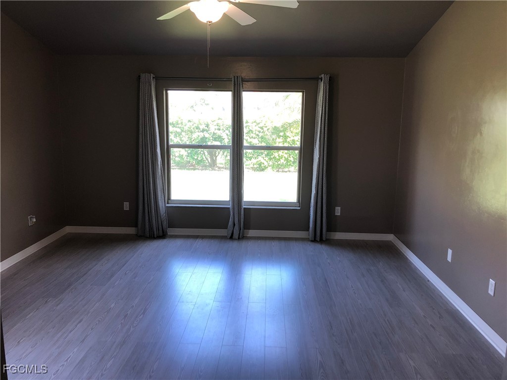 7500 Cameron Circle Fort Myers, FL 33912 - Photo 7 of 12 an empty room with wooden floor and windows