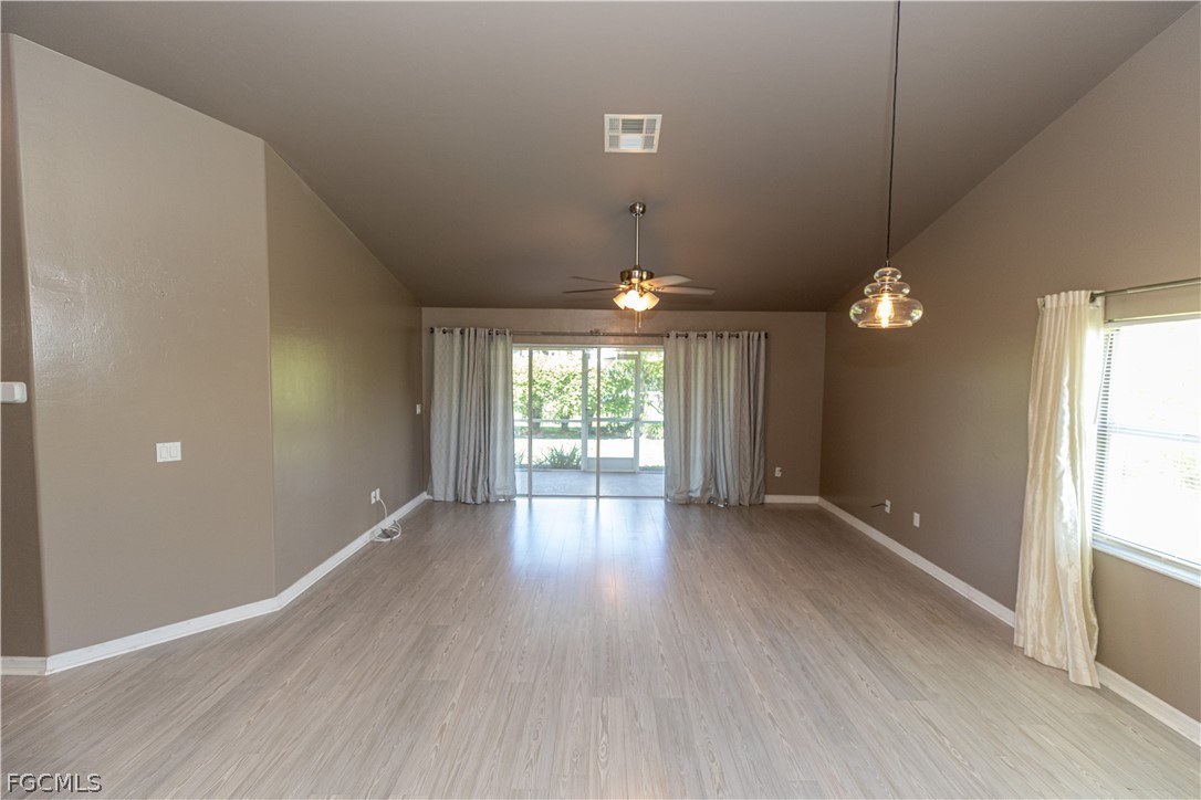 7500 Cameron Circle Fort Myers, FL 33912 - Photo 7 of 21 an empty room with wooden floor and windows