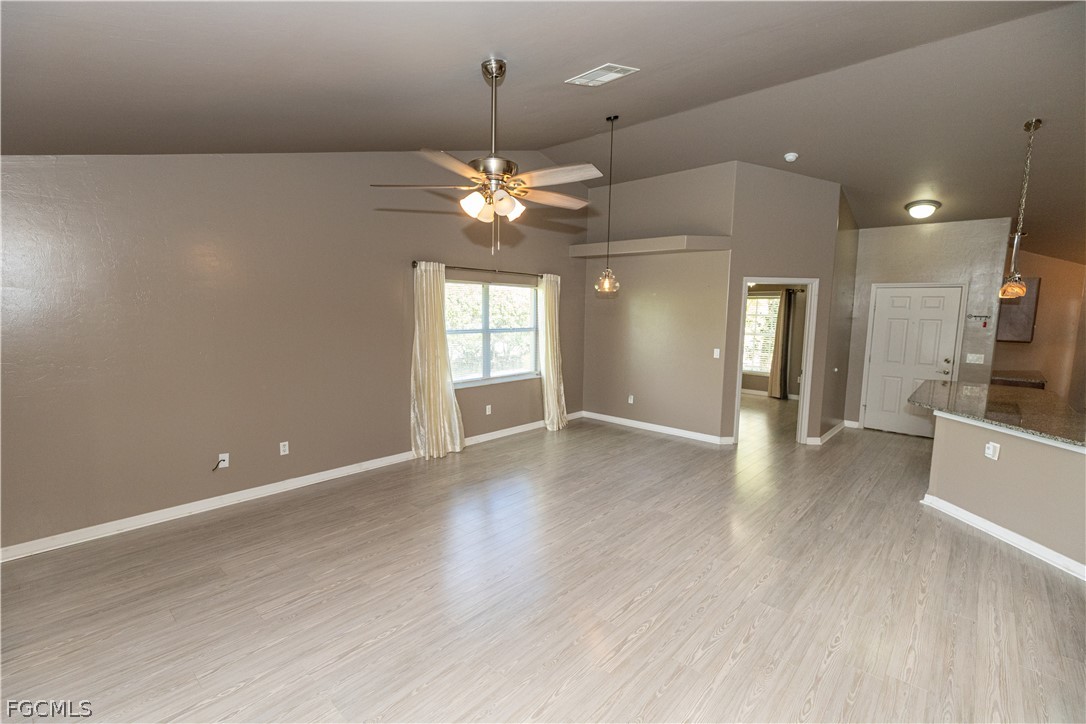 7500 Cameron Circle Fort Myers, FL 33912 - Photo 9 of 21 an empty room with wooden floor and fan