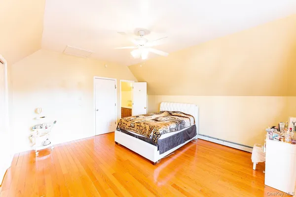 a living room with a bed and a potted plant