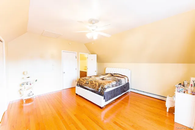 a living room with a bed and a potted plant