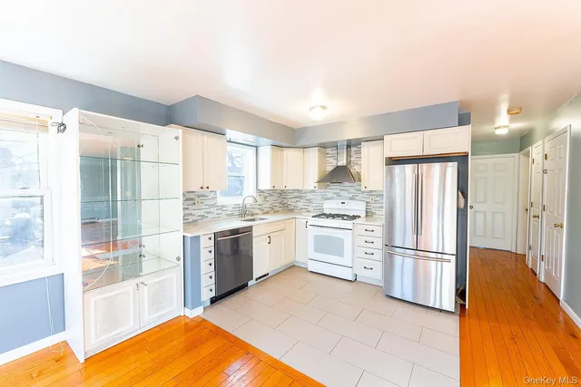 a open kitchen with stainless steel appliances granite countertop a refrigerator and a stove top oven