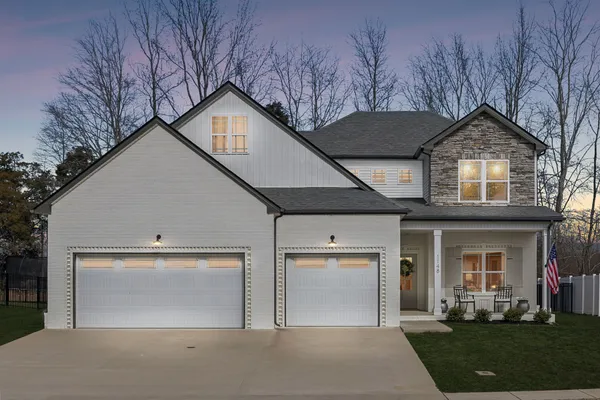 a front view of a house with a yard and garage