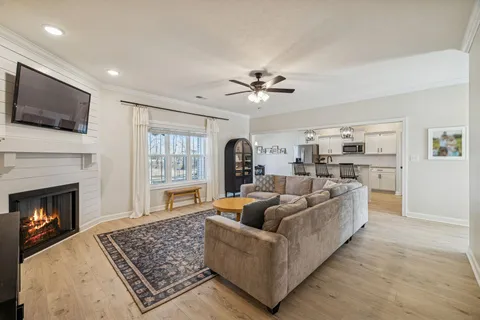 a living room with furniture a dining table and a large window