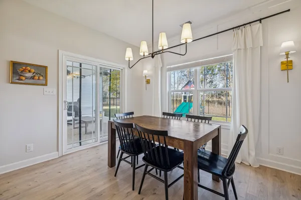 a living room with furniture a large window and a fireplace