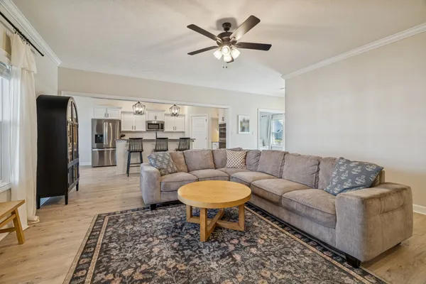 a bedroom with a flat screen tv on dresser and a flat screen tv