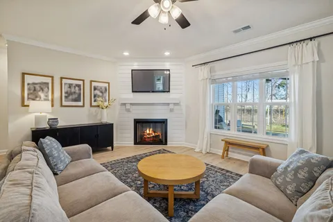 a bedroom with a flat screen tv on dresser and a flat screen tv
