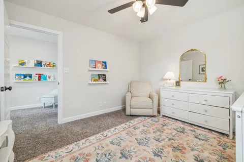 a bedroom with a bed and a book shelf