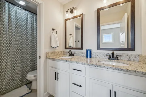 a bedroom with a bed a table and a window