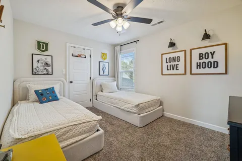 a bedroom with a bed and a chandelier