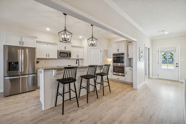 a kitchen with stainless steel appliances granite countertop a stove and a sink