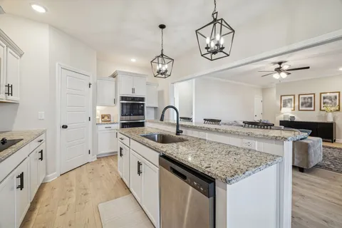 a kitchen with stainless steel appliances granite countertop a stove a microwave and a refrigerator