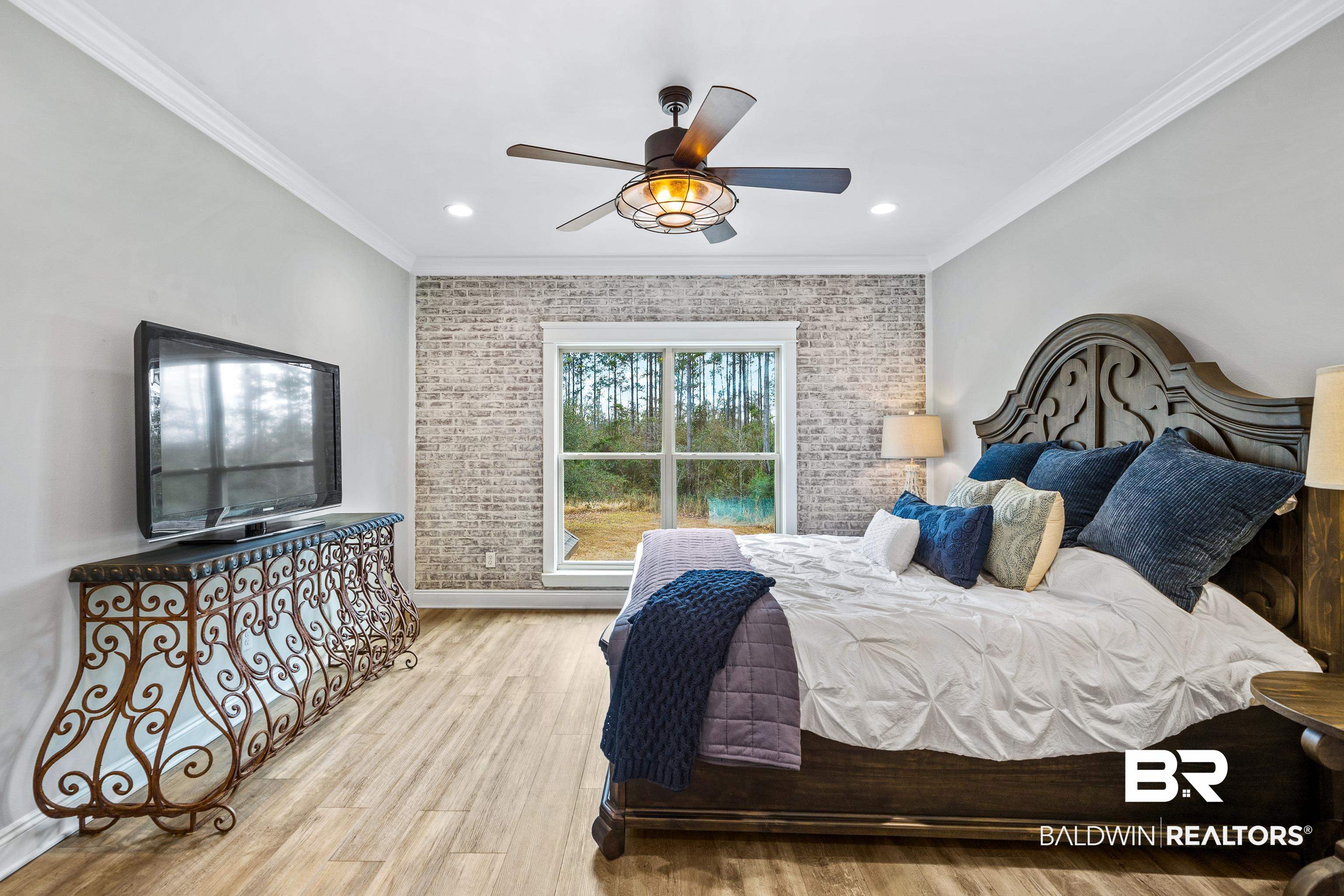 36784 Legacy Way Bay Minette, AL 36507 - Photo 35 of 57 Upper level bedroom featuring crown molding, brick wall, ceiling fan, wood-style floors and walk-in closet.