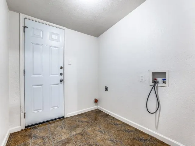 a view of a room with rack on the wall and a glass door