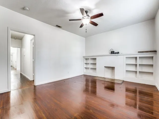 a view of a kitchen with wooden floor and electronic appliances