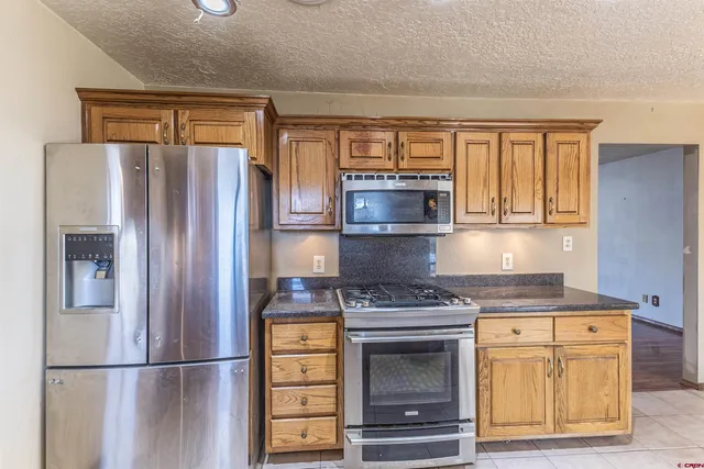a kitchen with stainless steel appliances granite countertop a sink stove and cabinets