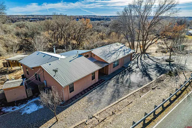 an aerial view of a house with a yard
